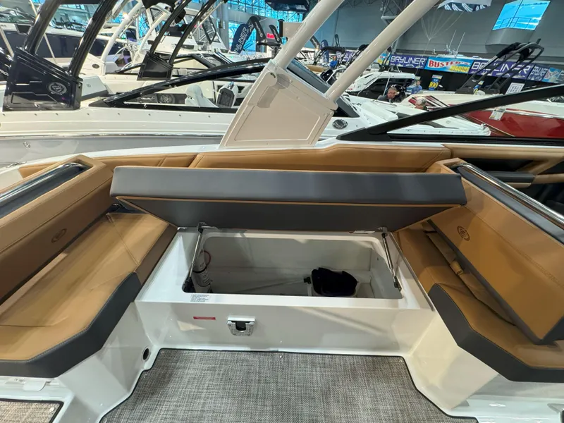 Slide: The Image of 2025 Cobalt R8 Outboard boat interior with tan seating and storage compartment. - 8