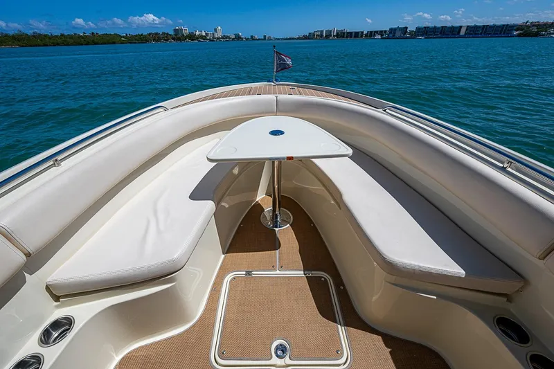 Slide: The Image of 2017 Chris-Craft Catalina 26 boat interior with seating and table, overlooking calm waters. - 13