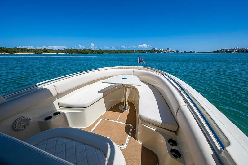 Slide: The Image of 2017 Chris-Craft Catalina 26 boat interior with seating, table, and ocean view. - 15
