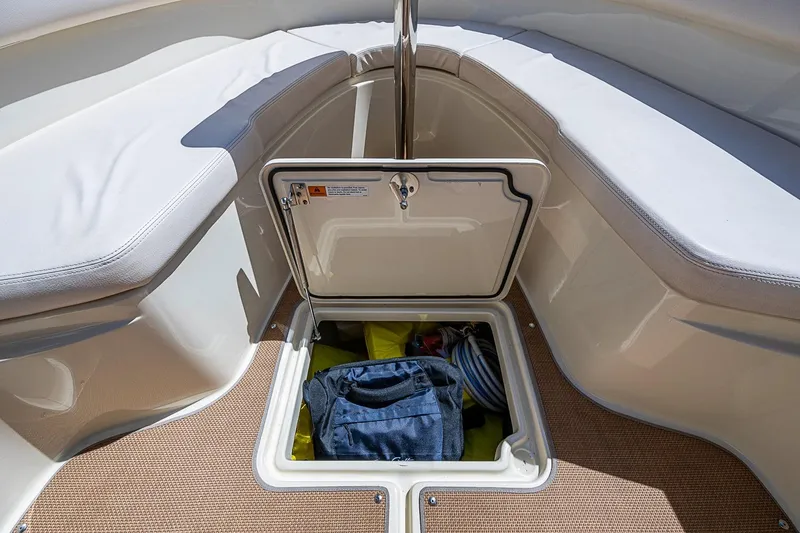 Slide: The Image of 2017 Chris-Craft Catalina 26 boat storage compartment with open hatch and visible contents. - 16