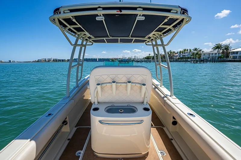 Slide: The Image of 2017 Chris-Craft Catalina 26 boat interior with seating, on a sunny day by the water. - 17