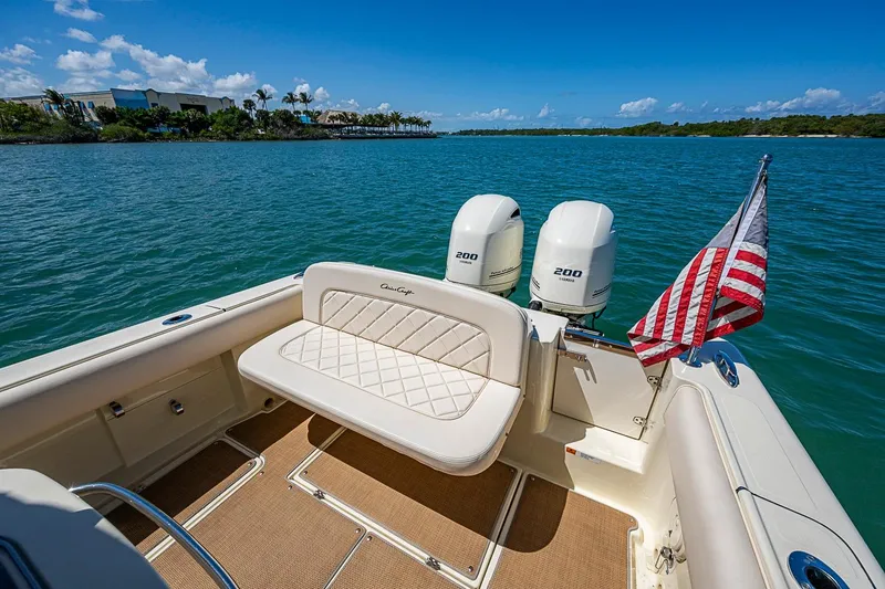 Slide: The Image of 2017 Chris-Craft Catalina 26 boat with twin engines and American flag on a sunny day. - 19