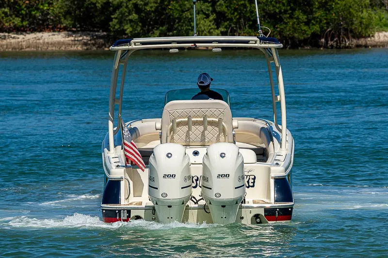 Slide: The Image of 2017 Chris-Craft Catalina 26 boat cruising on water with dual Yamaha engines. - 2
