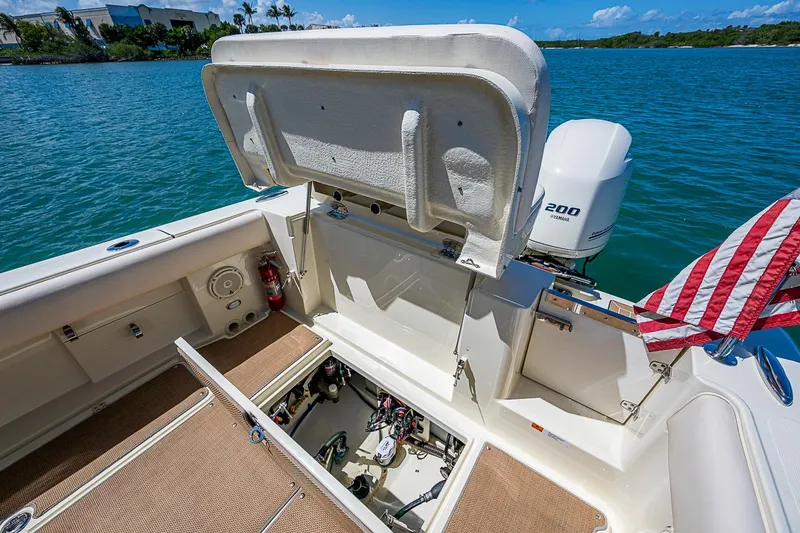 Slide: The Image of 2017 Chris-Craft Catalina 26 boat interior with open storage, American flag, and Yamaha engine. - 20