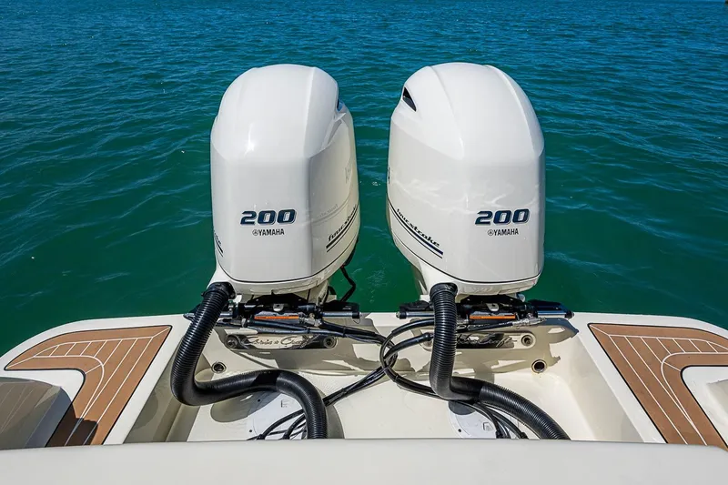 Slide: The Image of 2017 Chris-Craft Catalina 26 with twin Yamaha 200 engines on blue water. - 22