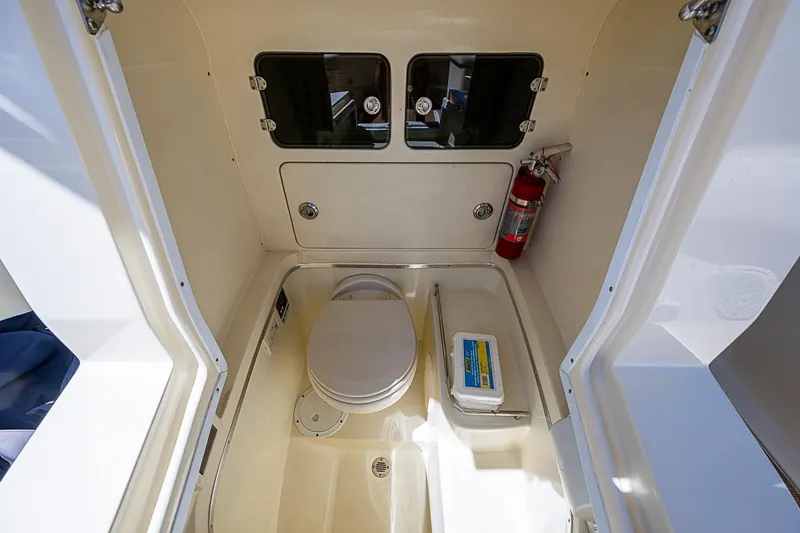 Slide: The Image of 2017 Chris-Craft Catalina 26 boat interior with toilet and fire extinguisher. - 24