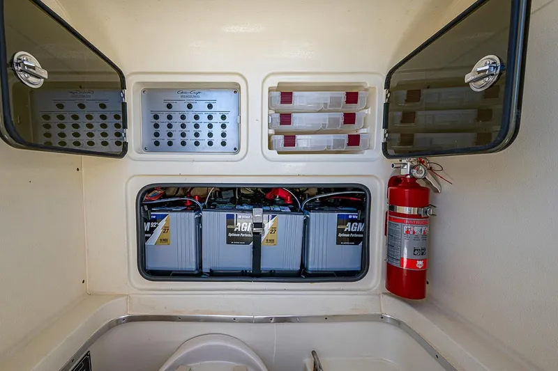 Slide: The Image of 2017 Chris-Craft Catalina 26 battery compartment with AGM batteries and fire extinguisher. - 25