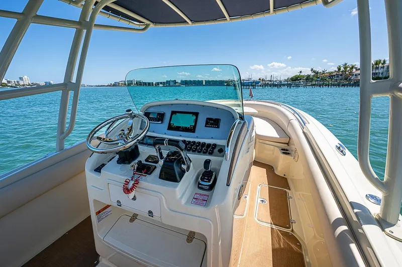 Slide: The Image of 2017 Chris-Craft Catalina 26 boat cockpit with steering wheel and navigation controls. - 5