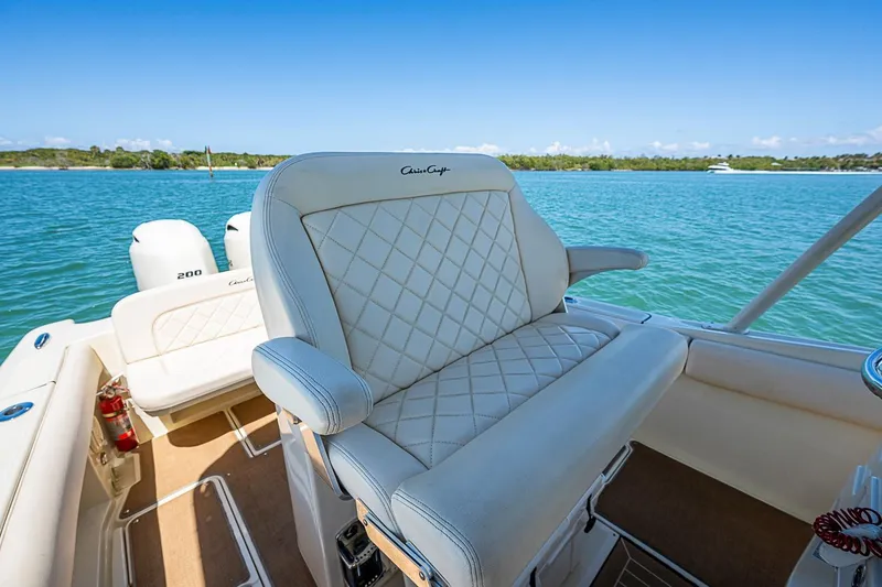 Slide: The Image of 2017 Chris-Craft Catalina 26 boat interior with luxurious seating on a sunny day. - 7