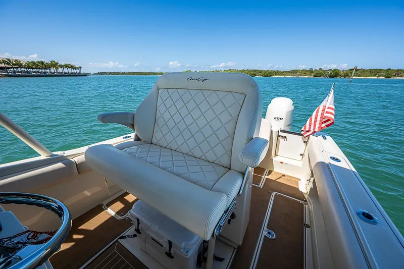 Slide: The Image of 2017 Chris-Craft Catalina 26 boat interior with luxurious seating and scenic water view. - 8