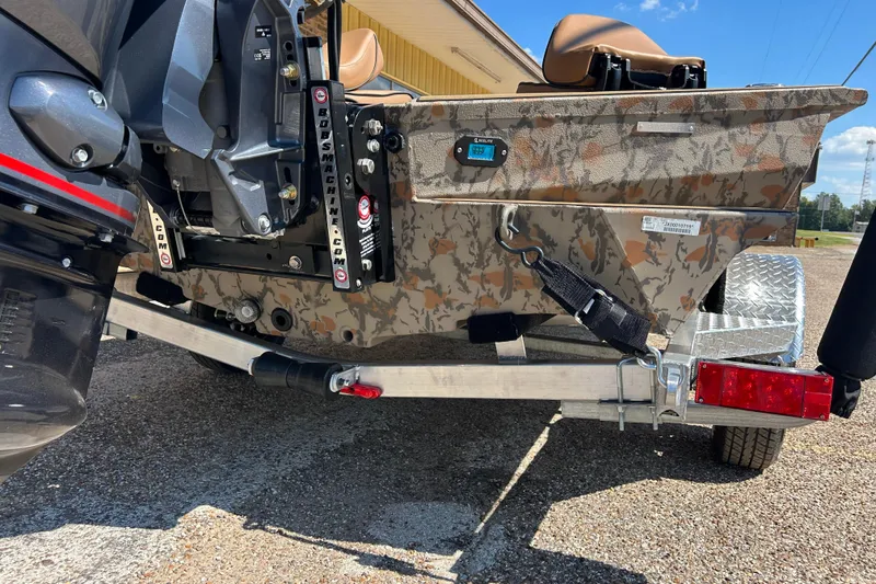 Slide: The Image of 2026 Xpress X18DB boat on trailer, featuring camo design and outboard motor. - 12