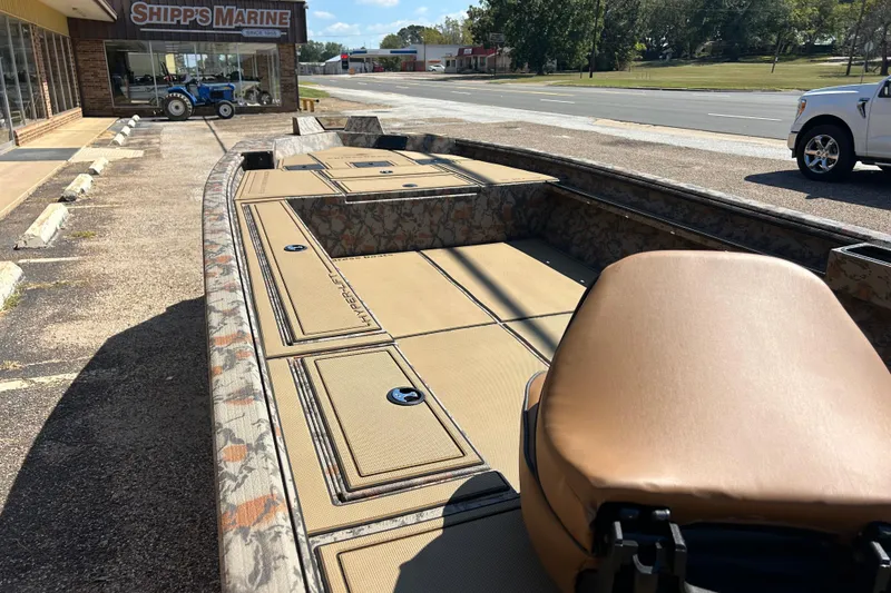 Slide: The Image of 2026 Xpress X18DB boat with camouflage design parked outside Shipp's Marine. - 8