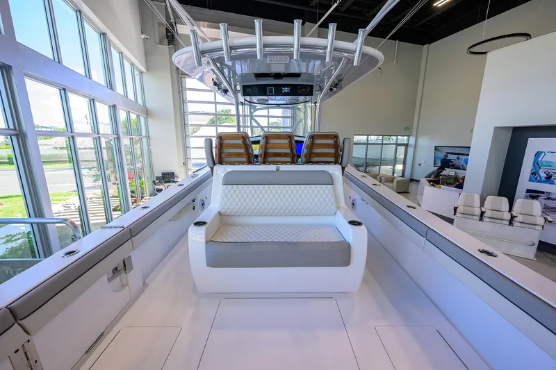 Slide: The Image of 2025 Valhalla Boatworks V-37 interior showcasing luxurious seating and modern design in a showroom. - 19