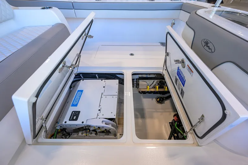 Slide: The Image of 2025 Valhalla Boatworks V-37 storage compartments open, showcasing interior equipment and wiring. - 27