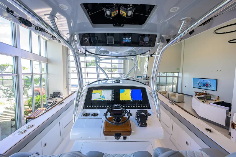 Slide: The Image of 2025 Valhalla Boatworks V-37 helm with advanced navigation systems in a showroom setting. - 6