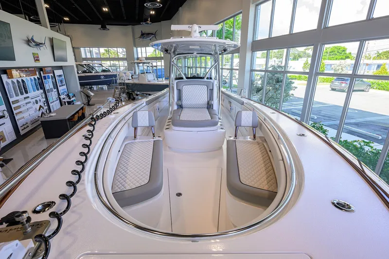 Slide: The Image of 2025 Valhalla Boatworks V-37 interior, showcasing luxurious seating and modern design in a showroom. - 9