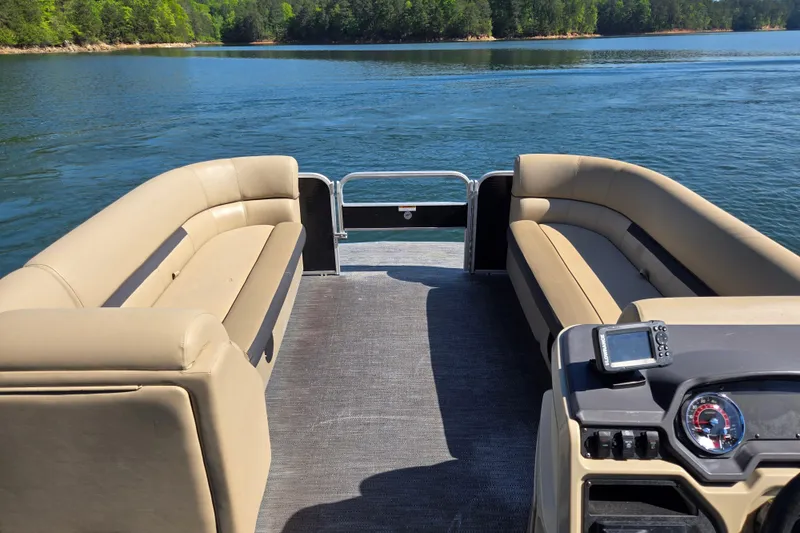 Slide: The Image of 2023 Godfrey Sweetwater 2286 C pontoon boat interior on a serene lake. - 10