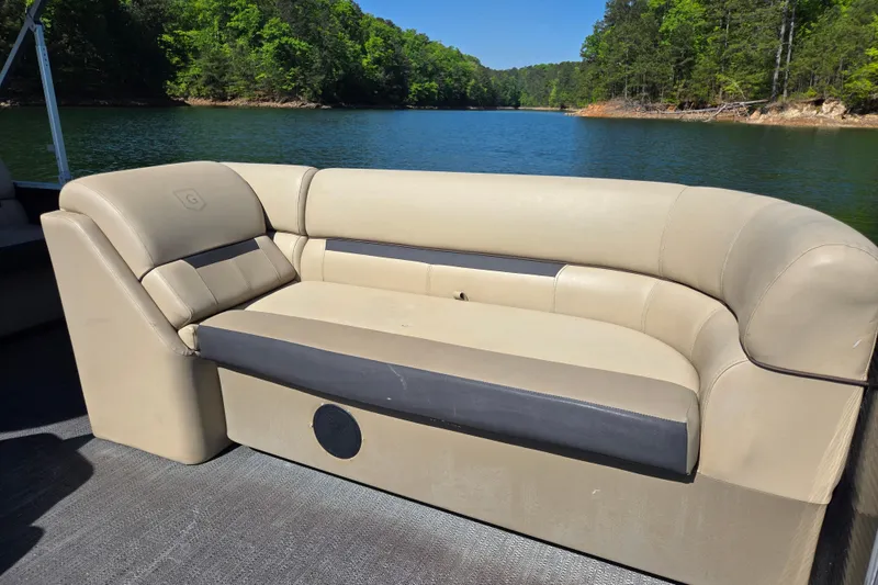 Slide: The Image of 2023 Godfrey Sweetwater 2286 C pontoon boat with beige seating on a serene lake. - 11
