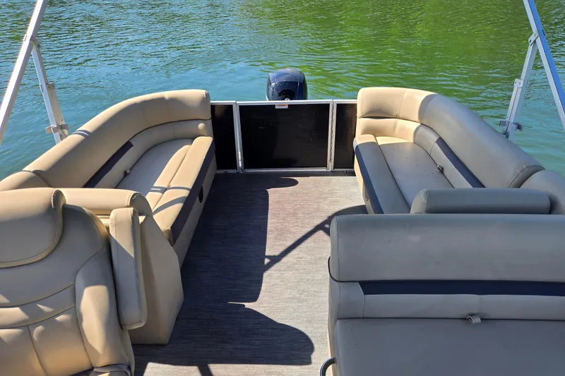 Slide: The Image of 2023 Godfrey Sweetwater 2286 C pontoon boat interior with beige seating on a lake. - 14