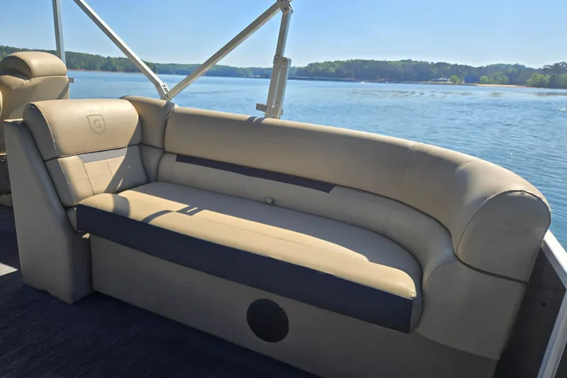 Slide: The Image of 2023 Godfrey Sweetwater 2286 C pontoon boat with comfortable seating by a serene lake. - 15