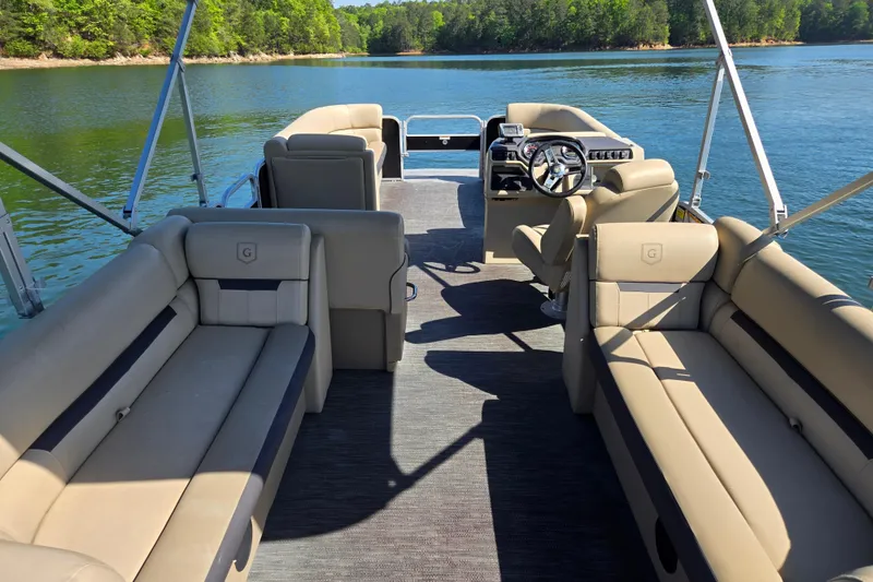 Slide: The Image of 2023 Godfrey Sweetwater 2286 C pontoon boat interior on a serene lake. - 17