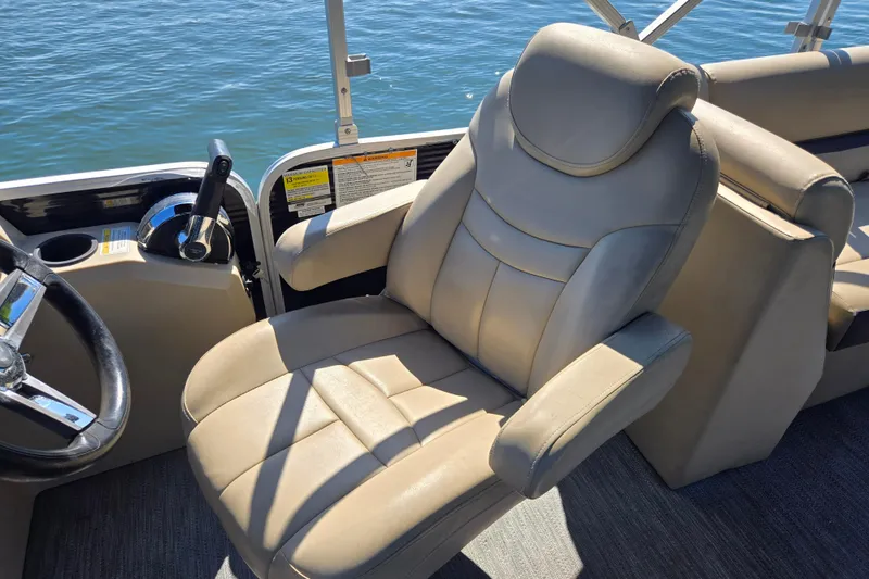 Slide: The Image of Captain's chair on 2023 Godfrey Sweetwater 2286 C pontoon boat, overlooking water. - 18