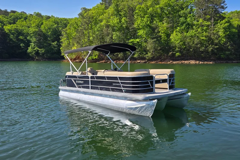 Slide: The Image of 2023 Godfrey Sweetwater 2286 C pontoon boat on a serene lake. - 3