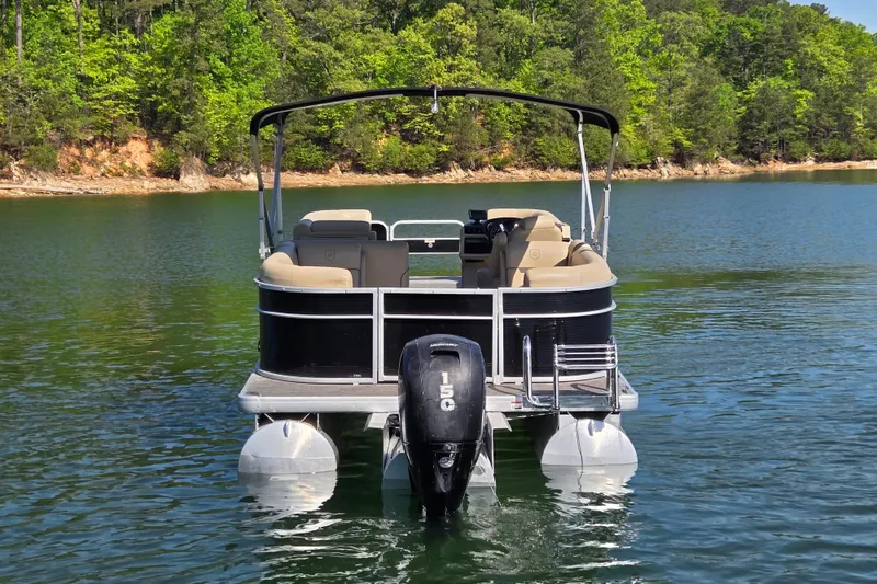 Slide: The Image of 2023 Godfrey Sweetwater 2286 C pontoon boat on a serene lake. - 6