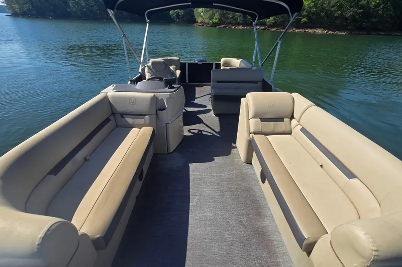 Slide: The Image of 2023 Godfrey Sweetwater 2286 C pontoon boat with beige seating on a serene lake. - 9