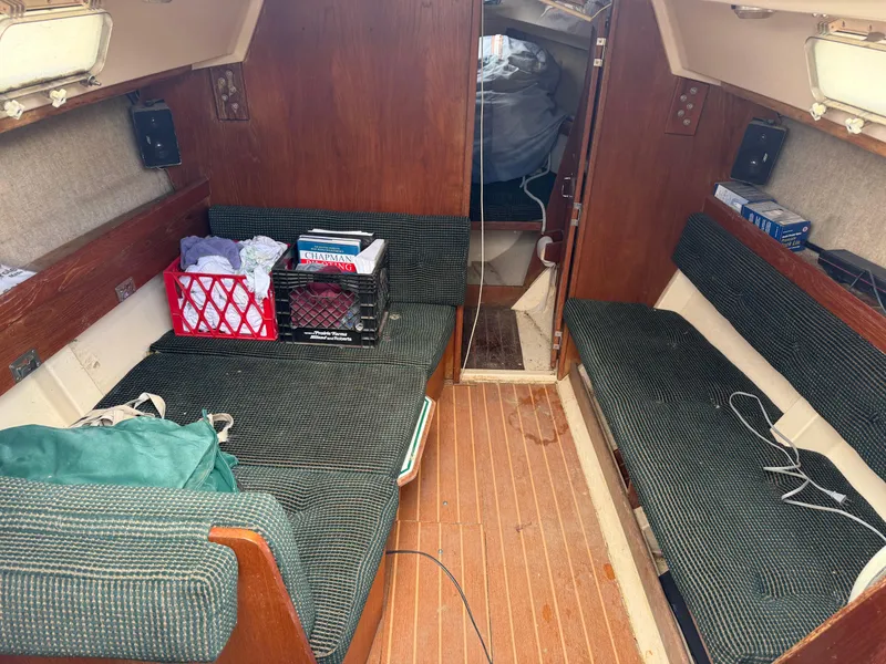 Slide: The Image of Interior of 1985 Hunter 25.5 sailboat with seating and storage crates. - 3
