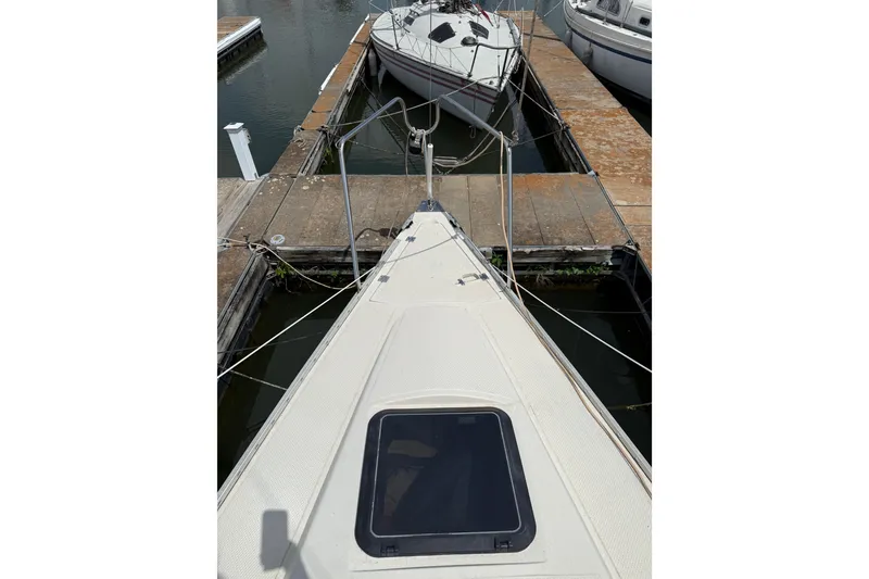 Slide: The Image of 1985 Hunter 25.5 sailboat docked at marina, viewed from the bow. - 5