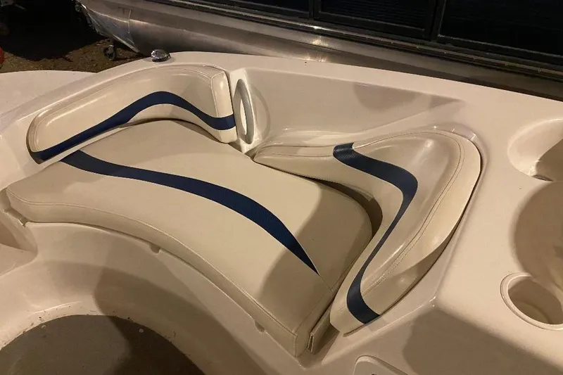 Slide: The Image of 2006 Starcraft 2000 IO Limited boat interior with blue and white cushioned seating. - 10
