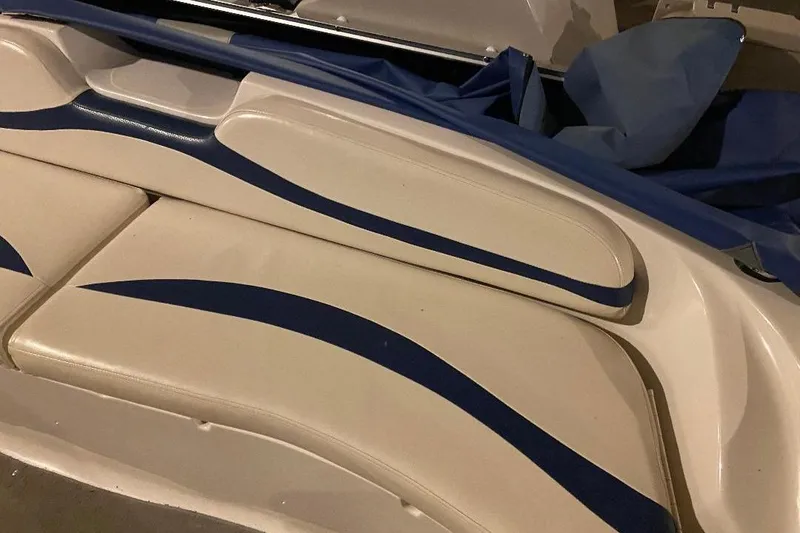 Slide: The Image of 2006 Starcraft 2000 IO Limited boat interior with blue and white seating. - 12
