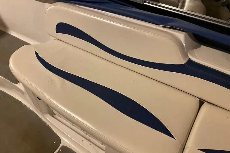 Slide: The Image of 2006 Starcraft 2000 IO Limited boat seat with blue and white upholstery design. - 13
