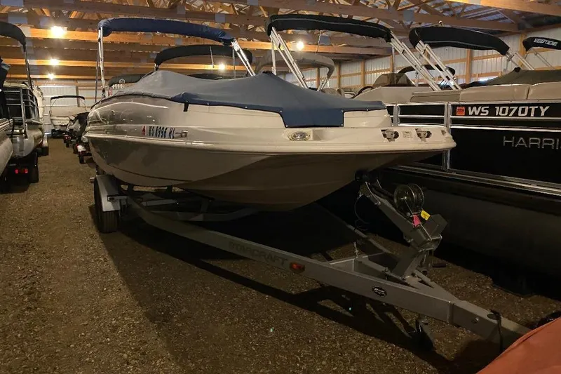 Slide: The Image of 2006 Starcraft 2000 IO Limited boat stored indoors on a trailer. - 2