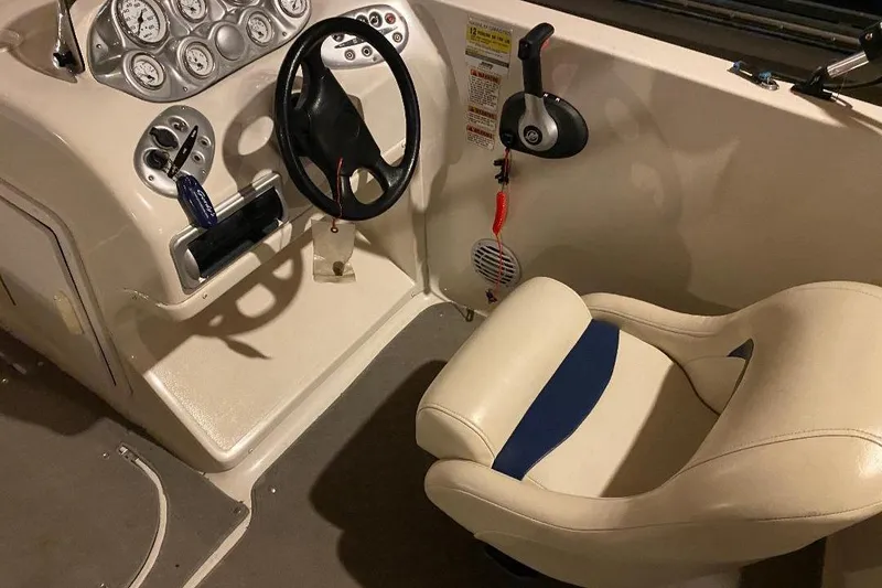 Slide: The Image of Interior of 2006 Starcraft 2000 IO Limited boat, featuring steering wheel and dashboard controls. - 6