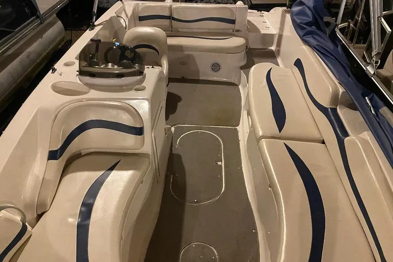 Slide: The Image of 2006 Starcraft 2000 IO Limited boat interior with beige and blue seating. - 8