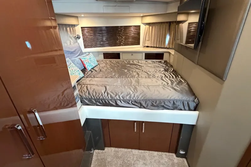 Slide: The Image of Luxurious 2019 Carver C34 yacht bedroom with modern decor and comfortable bedding. - 11