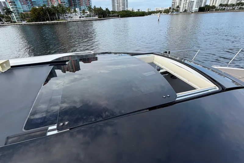 Slide: The Image of 2019 Carver C34 yacht with sunroof, docked by waterfront cityscape. - 17