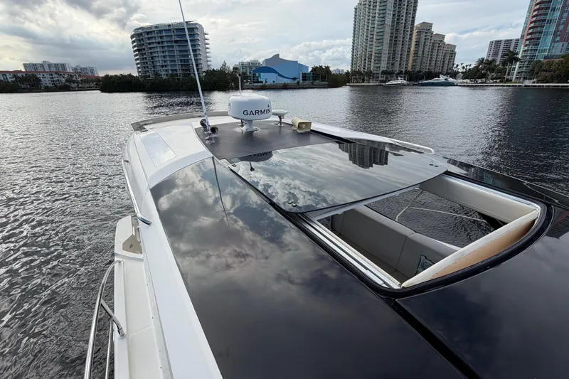 Slide: The Image of 2019 Carver C34 yacht on water, city skyline in background, overcast sky. - 19