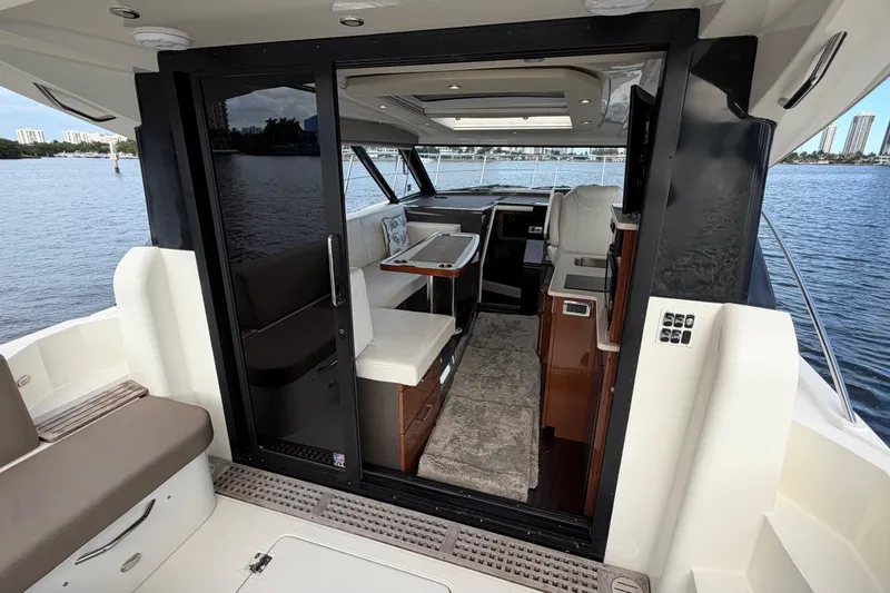 Slide: The Image of 2019 Carver C34 yacht interior with seating, table, and water view. - 20
