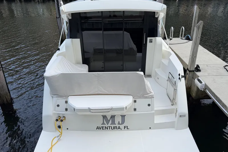 Slide: The Image of 2019 Carver C34 yacht docked in Aventura, FL, rear view with covered seating. - 22
