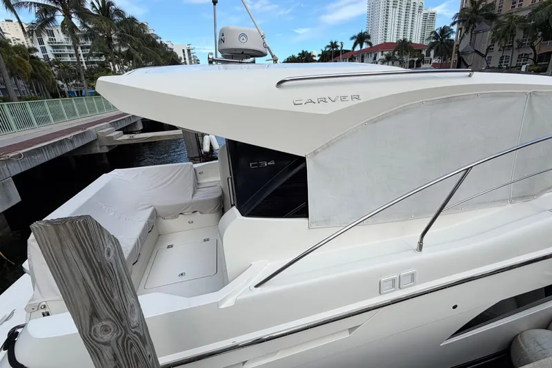 Slide: The Image of 2019 Carver C34 yacht docked, featuring sleek design and modern amenities. - 24