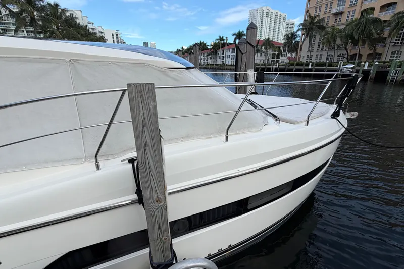 Slide: The Image of 2019 Carver C34 yacht docked in a scenic waterfront location. - 25