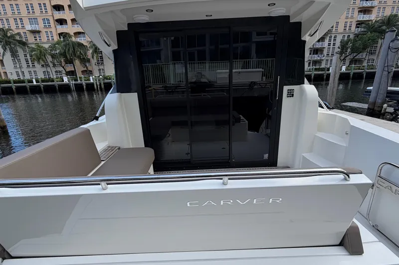 Slide: The Image of 2019 Carver C34 yacht with sleek design, docked near waterfront buildings. - 27