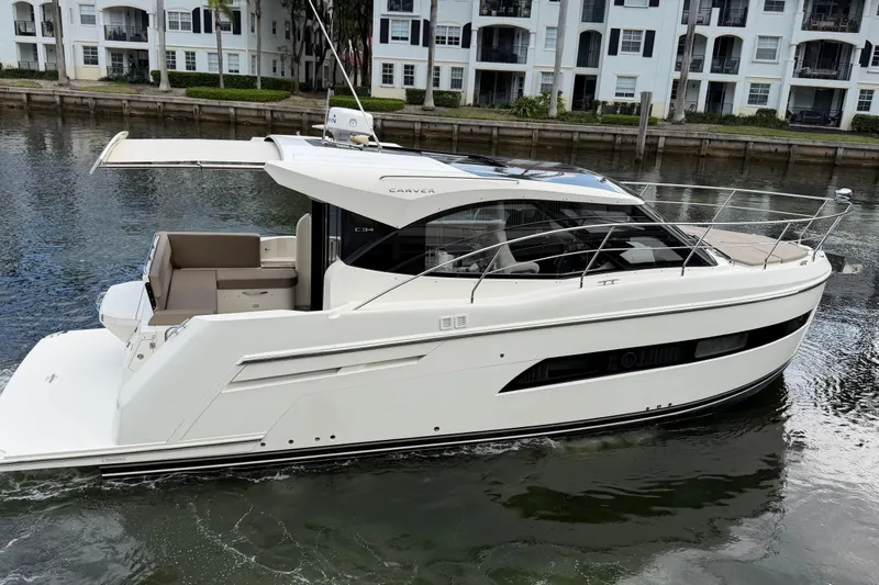 Slide: The Image of 2019 Carver C34 yacht on water, modern design, dockside view. - 3