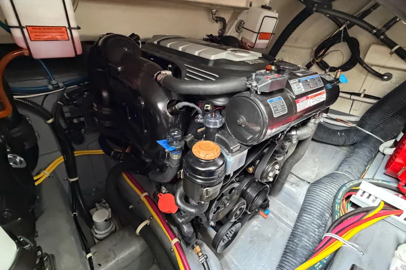 Slide: The Image of Engine compartment of a 2019 Carver C34 boat, showcasing detailed mechanical components. - 31