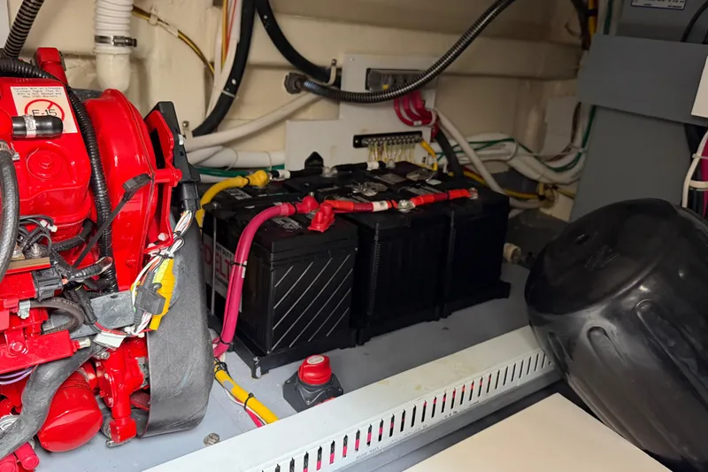 Slide: The Image of Engine room of 2019 Carver C34 with battery and wiring components. - 33
