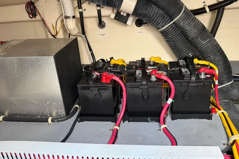 Slide: The Image of Battery compartment of a 2019 Carver C34 with wiring and ventilation hoses. - 35