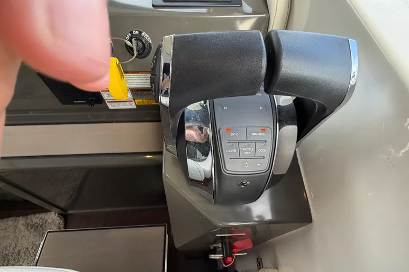 Slide: The Image of 2019 Carver C34 throttle controls with ignition key and control panel. - 5